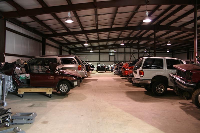 A storage evidence warehouse with various cars from accidents