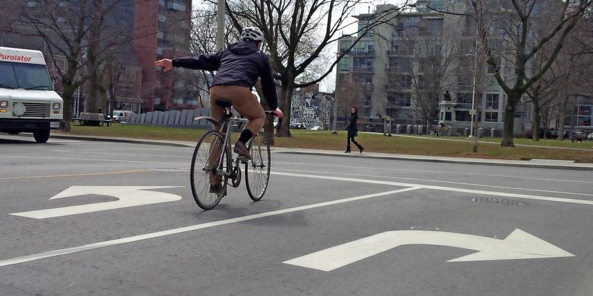 bike rider signaling to drivers
